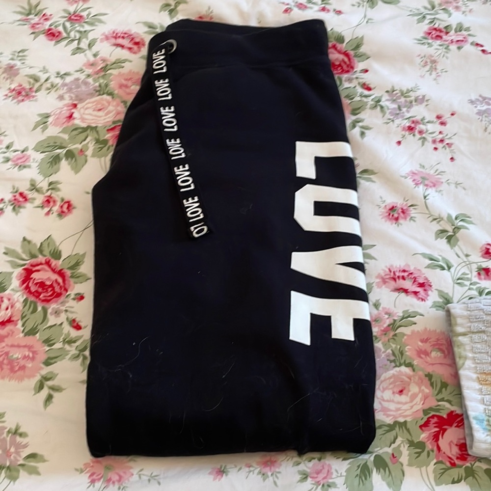 Black sweatpants with love on each side! Drawstring says love! Two pockets! New